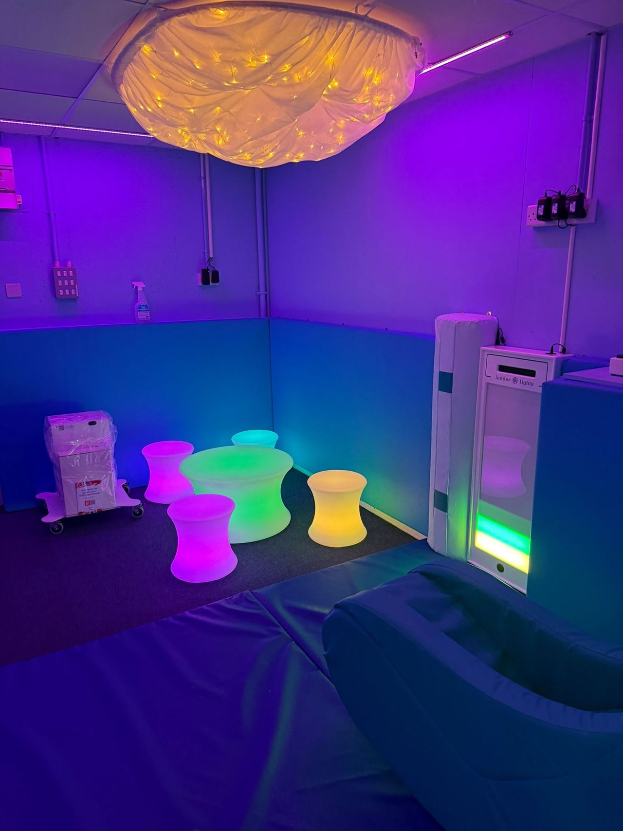 Finished Sensory Room with neon mood lighting and padding